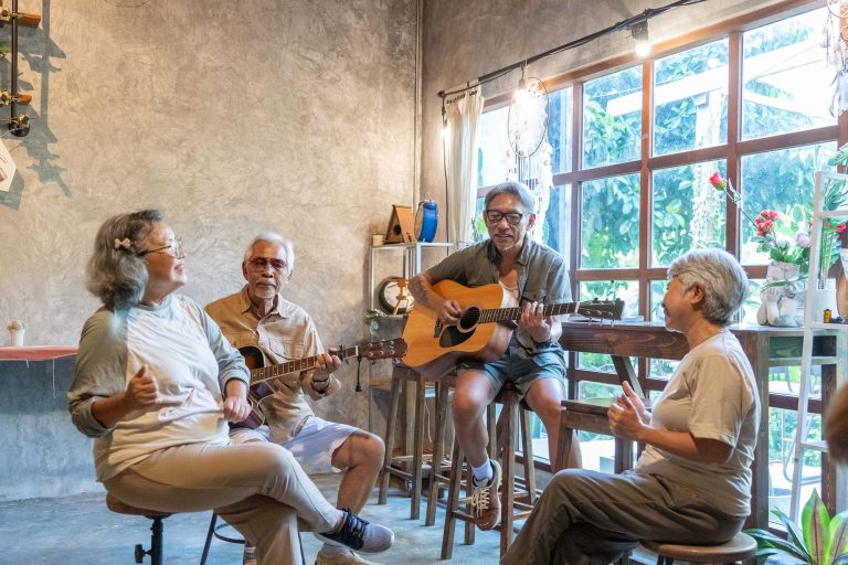 Group of seniors playing guitar.