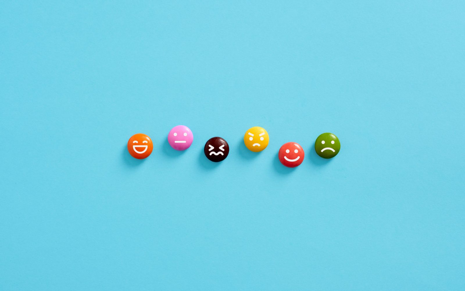 Small emoticons showing different emotions on a blue background.