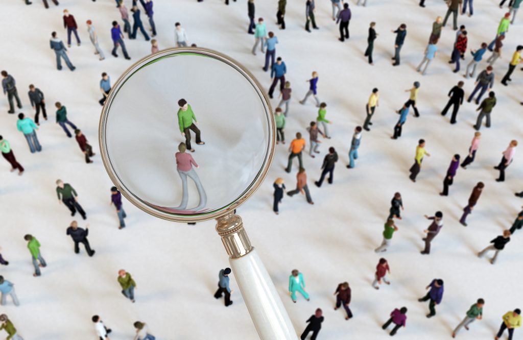 Zoom in with magnifying glass on crowd of people.
