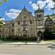 People walking in front of a large building on the University of Michigan campus