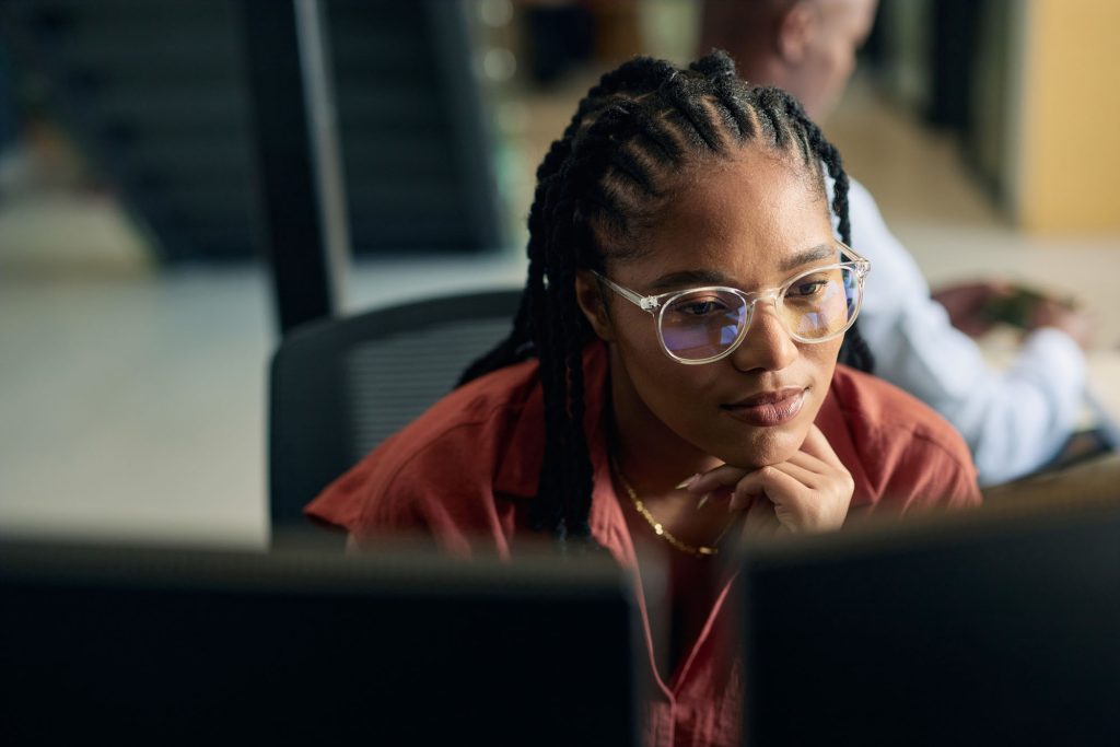 Young woman programmer focused on her work.