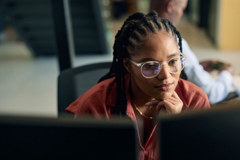 Young woman programmer focused on her work.
