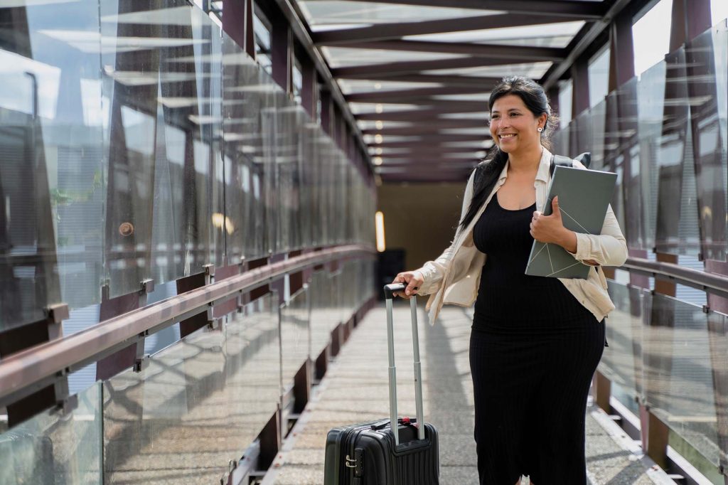 Woman walks at the airport for her next business trip.