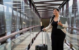 Woman walks at the airport for her next business trip.