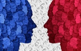 Abstract illustration of red and blue faces looking at each other.