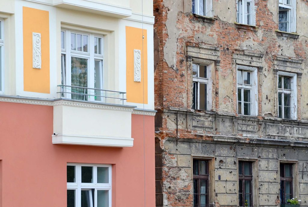 Contrast on one street. One building recently renovated another still with bullet holes from war.