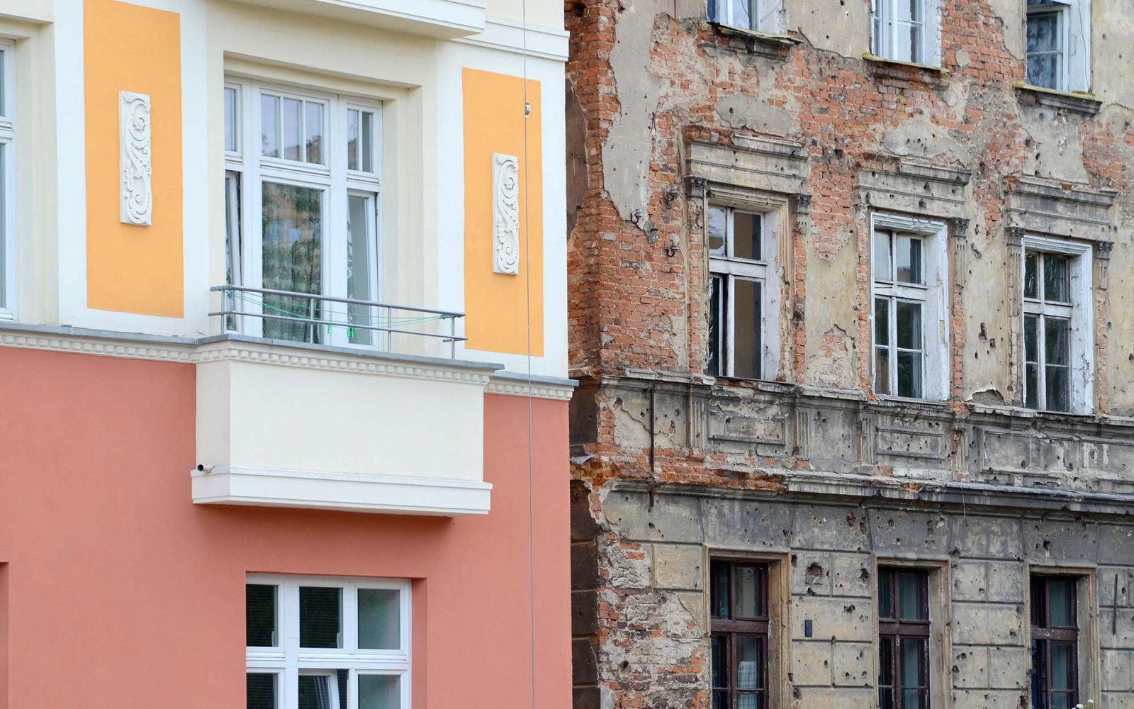 Contrast on one street. One building recently renovated another still with bullet holes from war.