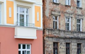 Contrast on one street. One building recently renovated another still with bullet holes from war.