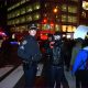 A police officer stands next to a photographer during a protest after Eric Garner's death.