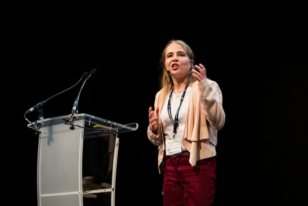 Carla Groom speaking on a stage.