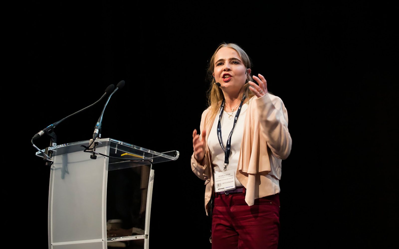 Carla Groom speaking on a stage.