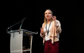 Carla Groom speaking on a stage.