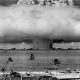 A large mushroom cloud spans the horizon, black and white photo.