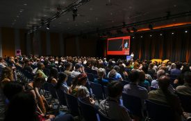A shot from behind a packed crowd at an APS 2026 plenary.