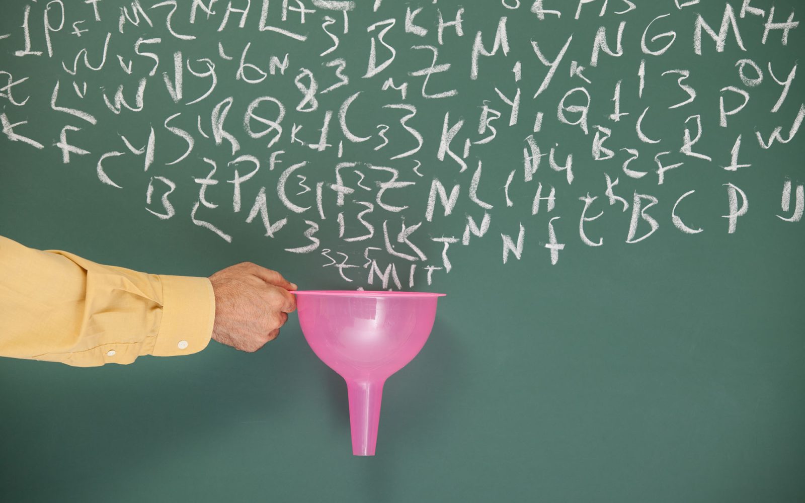 Hand holding a funnel to a chalkboard with letters, imitating filtering through the funnel.