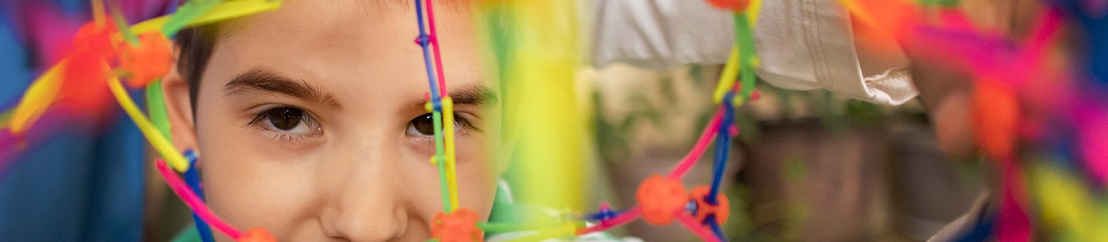 A female nurse works with an autistic boy using colorful sensory toys to develop motor skills.