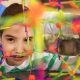 A female nurse works with an autistic boy using colorful sensory toys to develop motor skills.