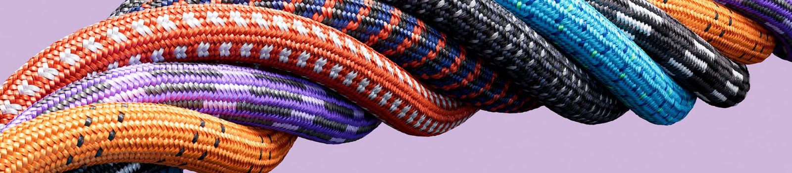 Multicolored ropes bound together to create one large rope.