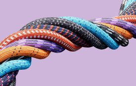 Multicolored ropes bound together to create one large rope.