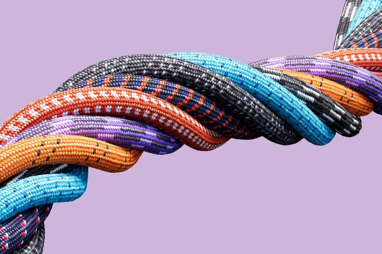 Multicolored ropes bound together to create one large rope.