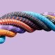 Multicolored ropes bound together to create one large rope.